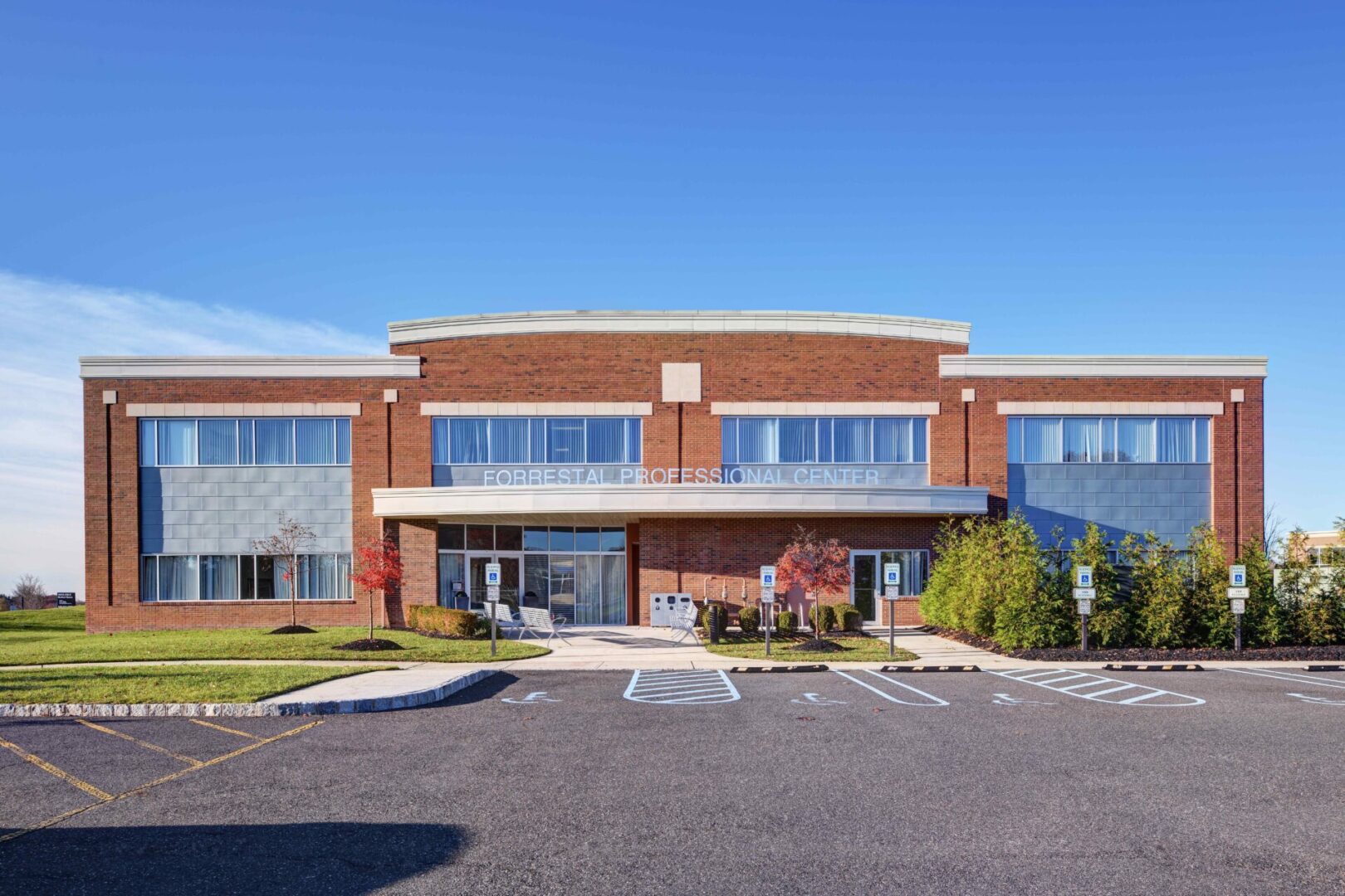 A large brick building with many windows and a parking lot.