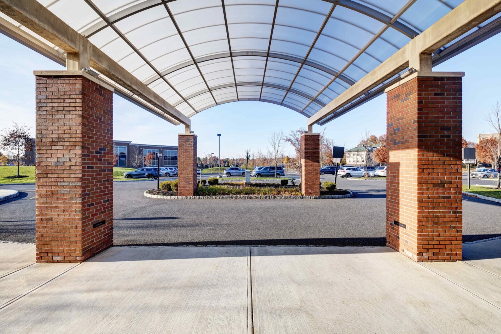 A large open area with brick pillars and a clear roof.