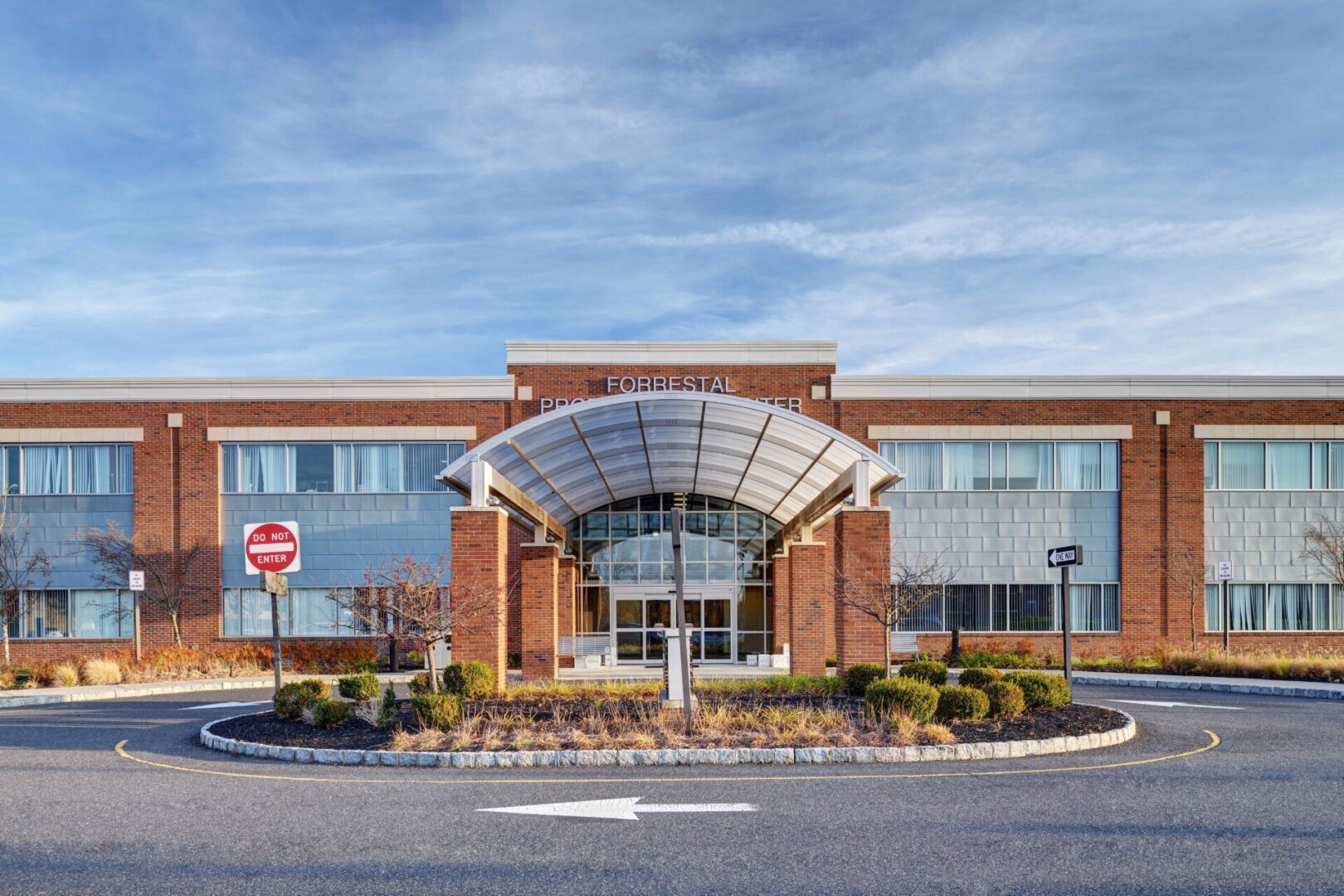 A large building with a parking lot in front of it.