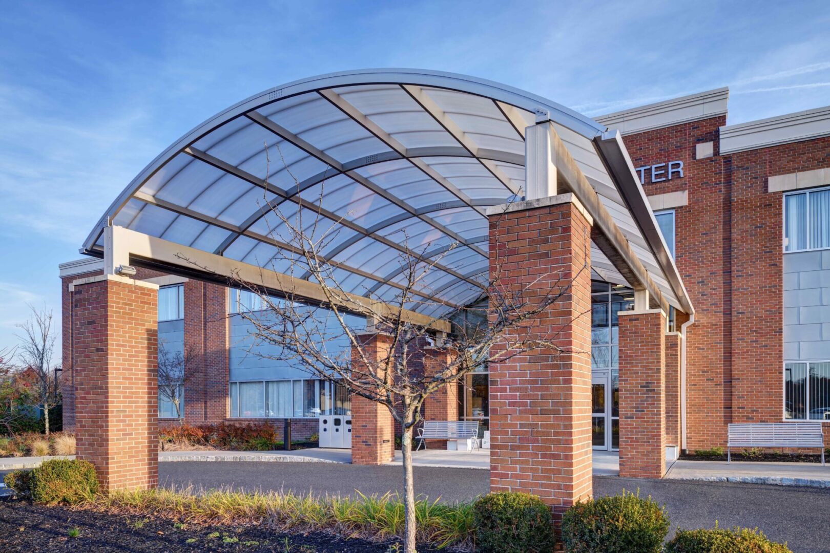 A building with brick pillars and an arch.