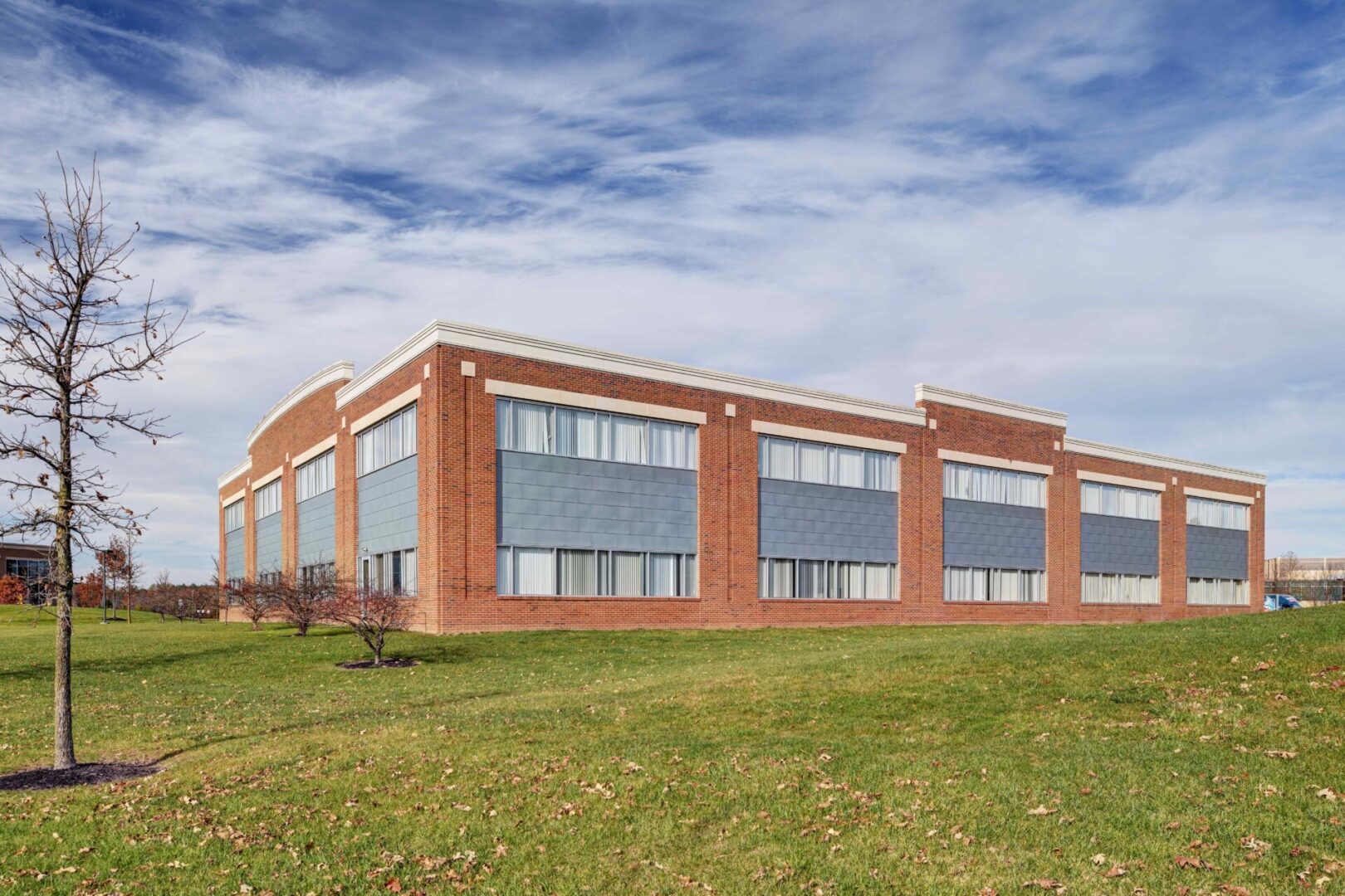 A large brick building with many windows on the side.