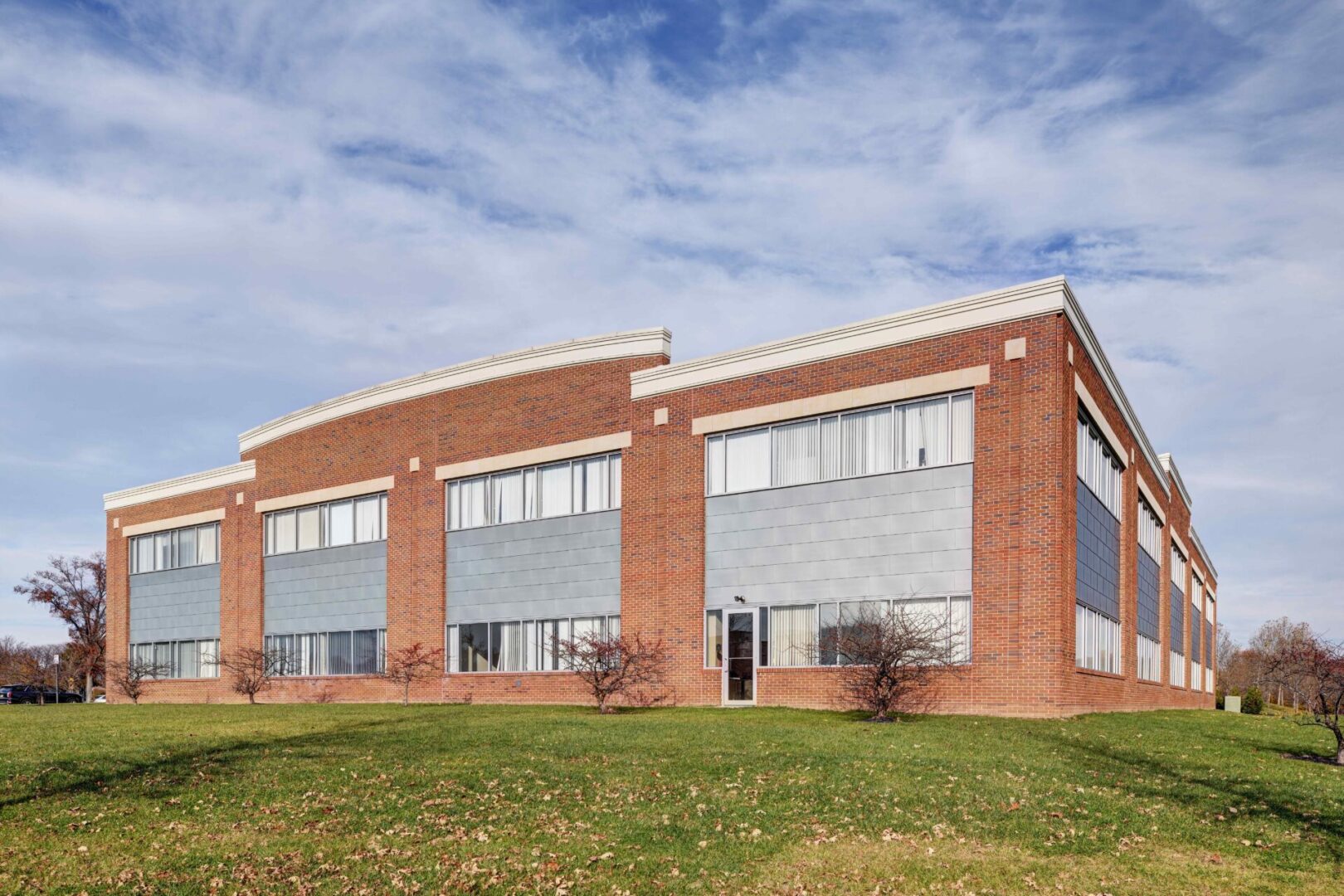 A large brick building with windows on the side of it.