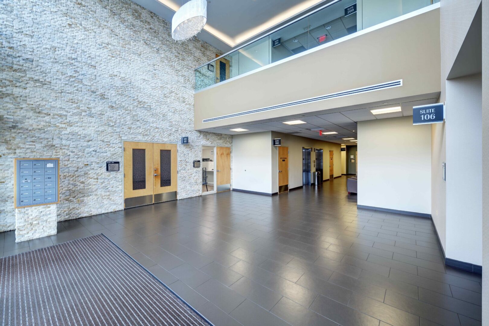 A large room with two doors and a ceiling.