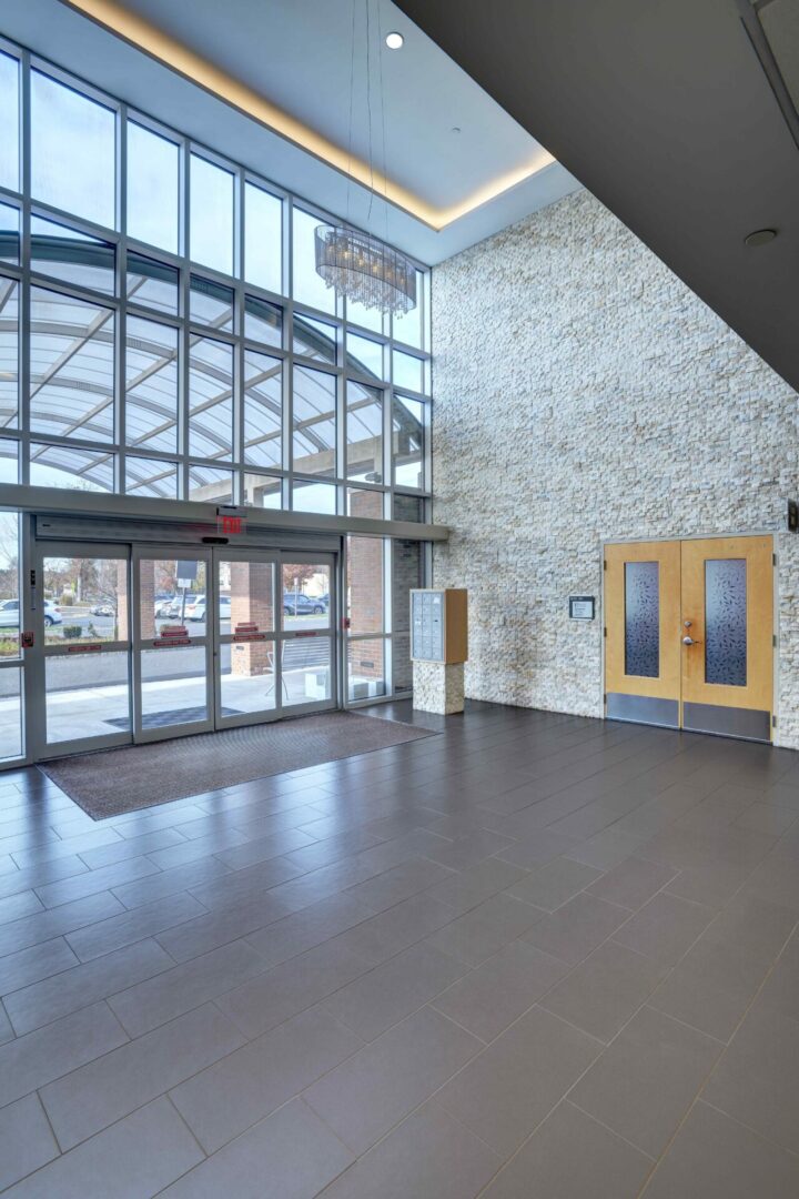 A large open lobby with two doors and a glass wall.