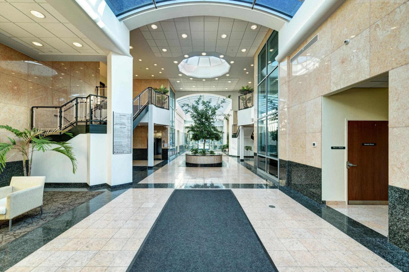 A large hallway with a plant in the middle of it.