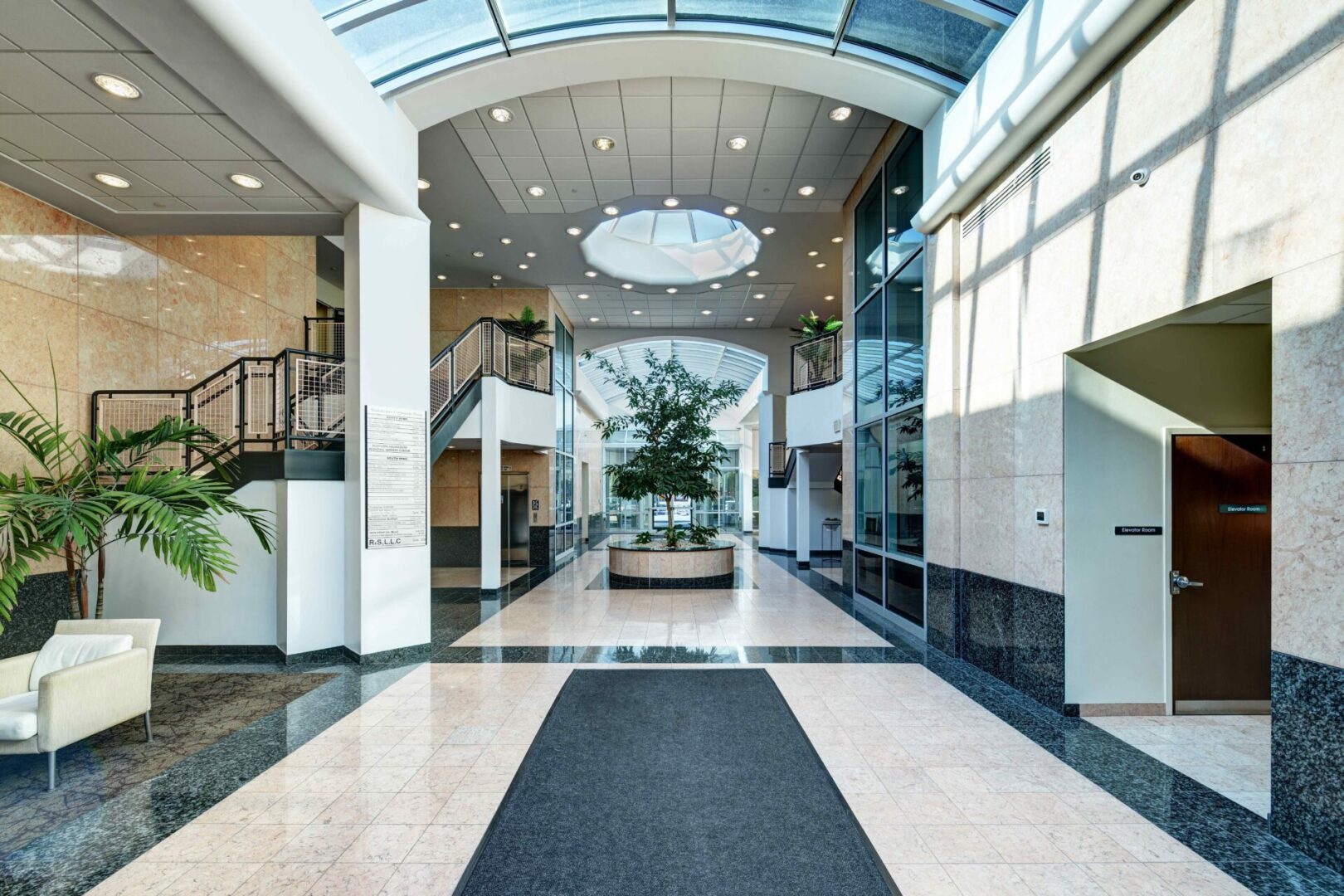 A large lobby with many windows and glass doors.