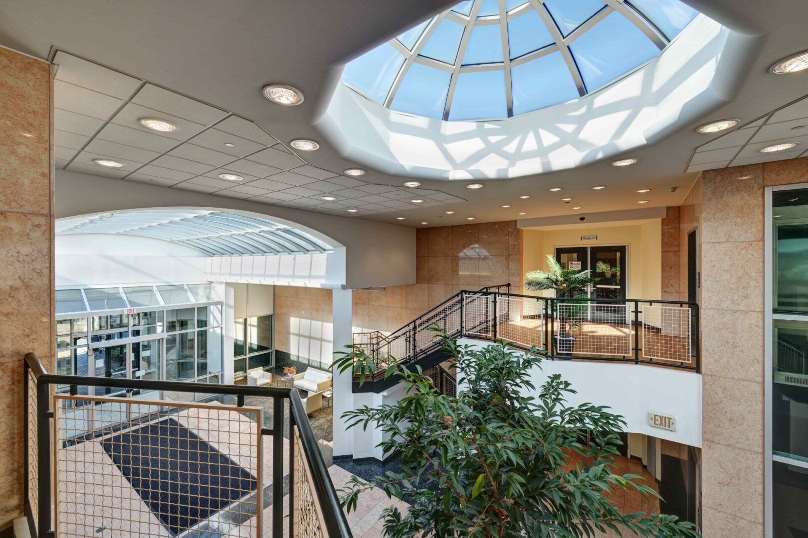 A large atrium with stairs and plants in it.