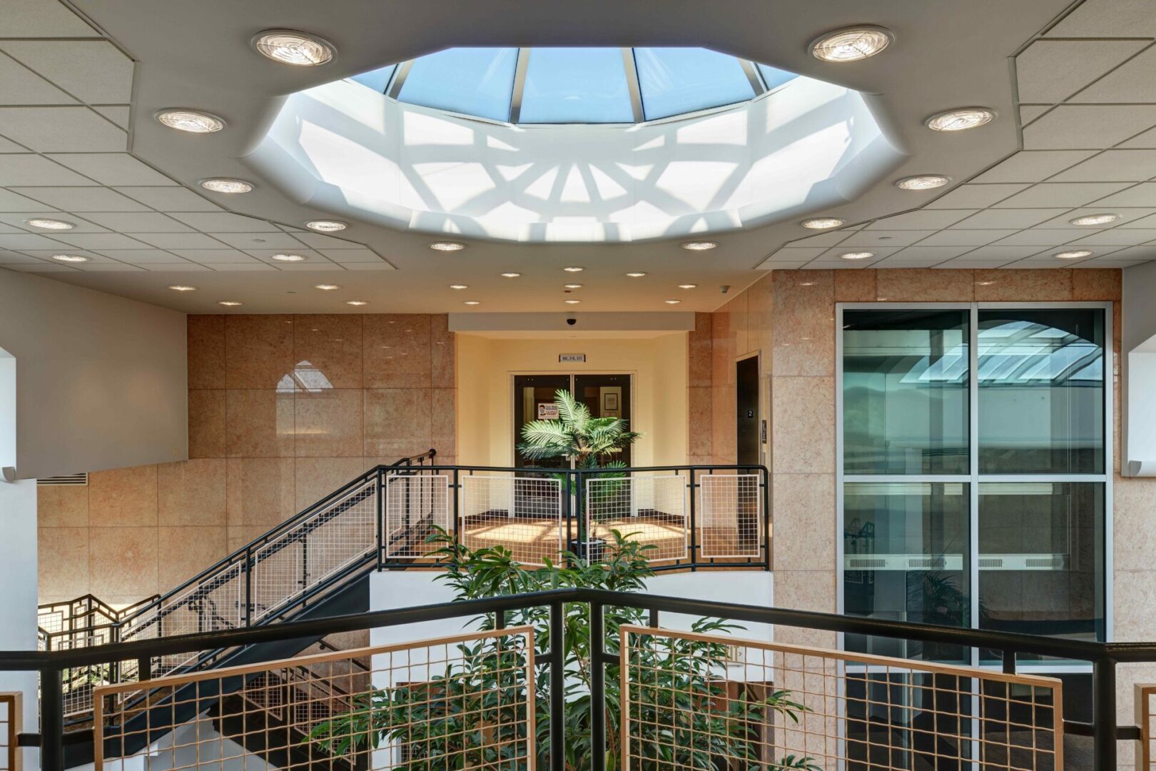 A large atrium with stairs and plants in the center.