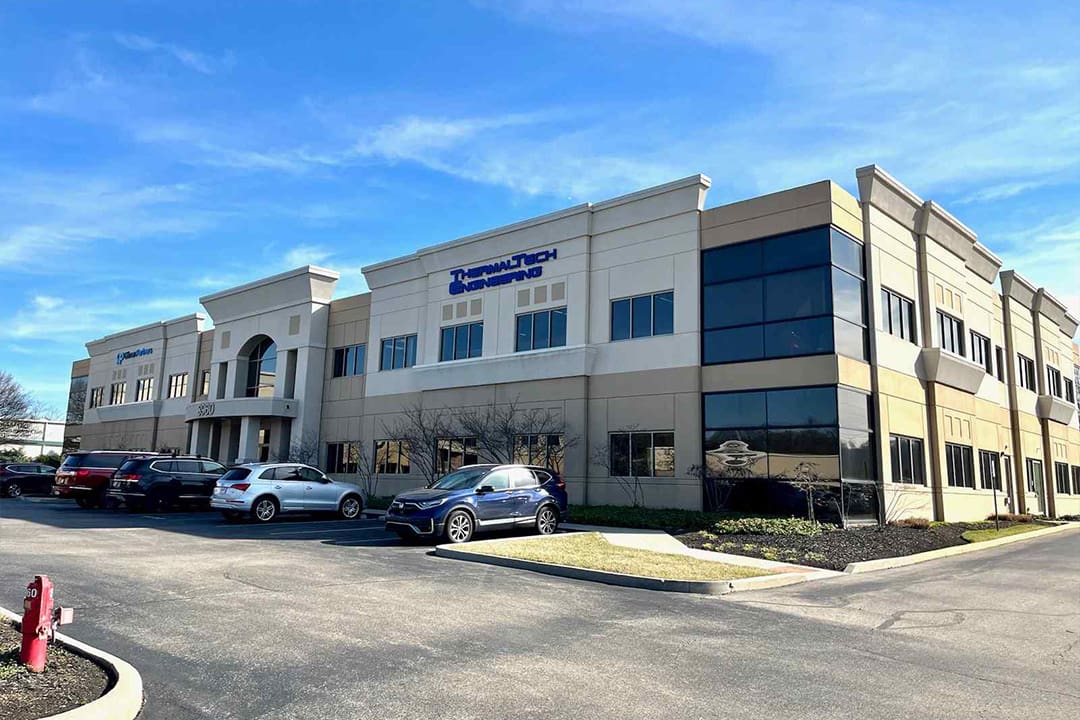 A large building with cars parked in front of it.